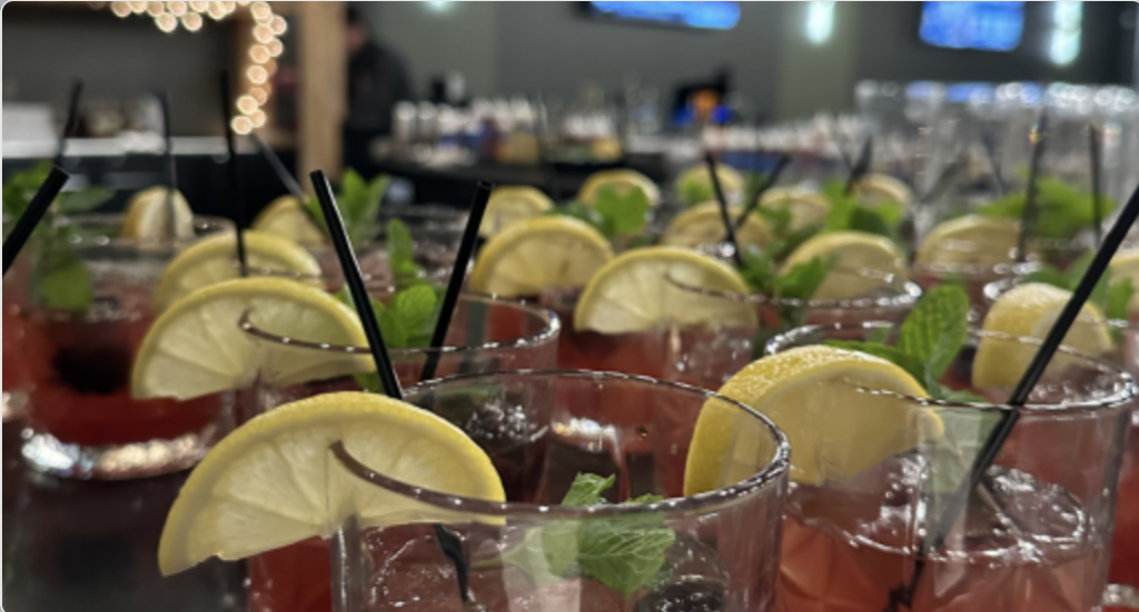 Image of Inside the Highline Room in Dexter Michigan of cocktails lined up, sitting on a bar.